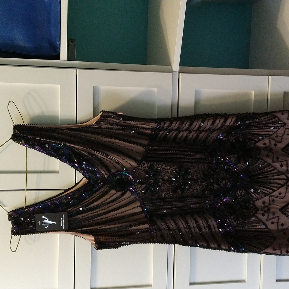 Woman size medium vintage dress with shingles at the bottom